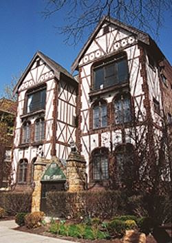 A large white home with brown trim.