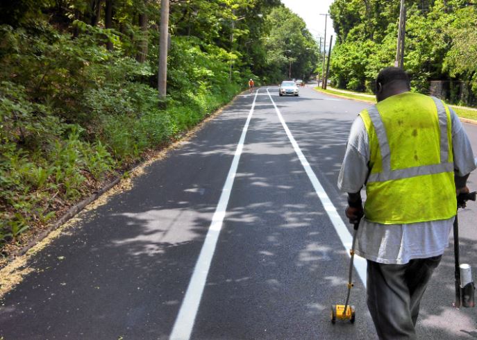 Road worker walking along roadside