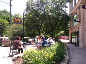 A patio eating area on a sidewalk.